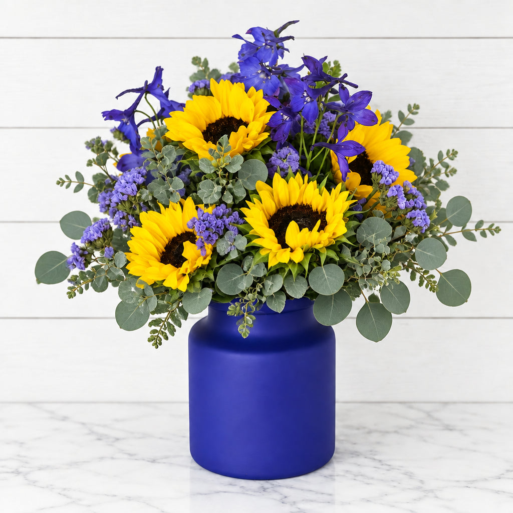 Blue florals and yellow sunflower arrangement
