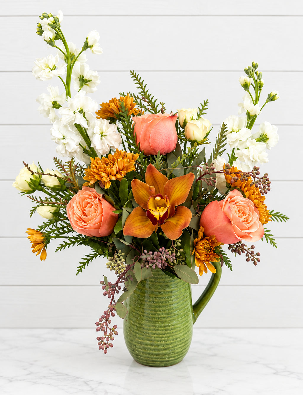 Fall floral mix in auburn orange and peach hues.
