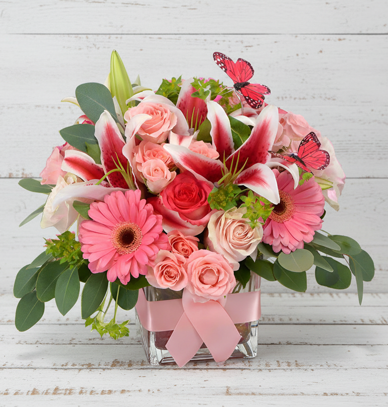 Pink Butterflies floral arrangement with lilies, roses, and gerbera daisies in a glass vase.