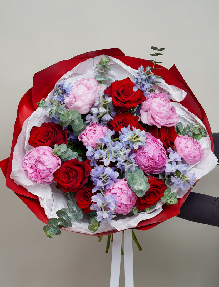 Peony red rose blue delphinium wrapped bouquet