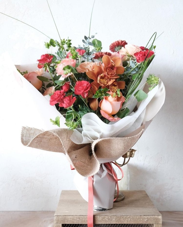 Coral rose mix flower wrapped bouquet same day flower delivery Chicago, IL